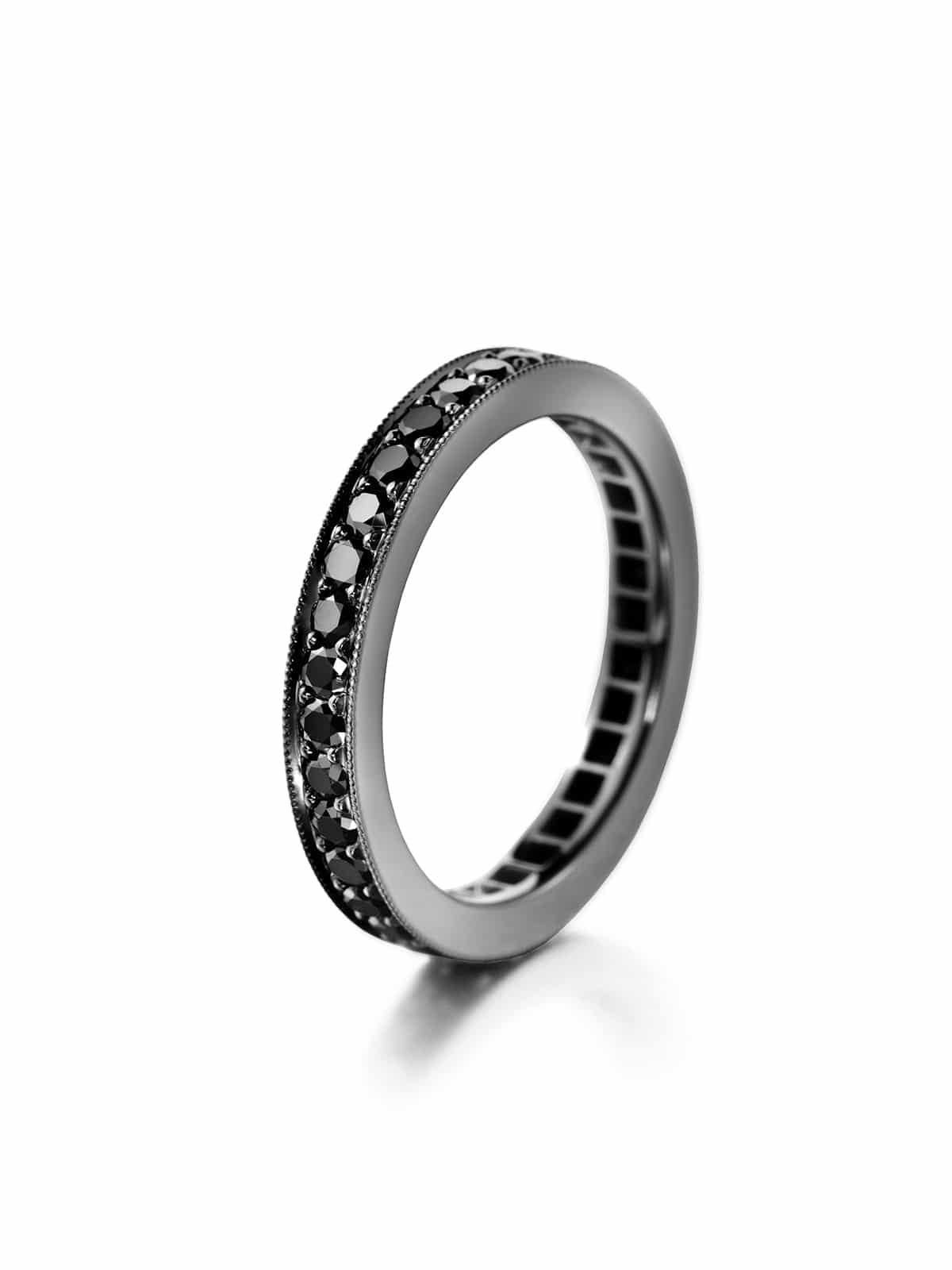 A black diamond eternity ring with the diamonds set in a bead pattern around the entire band.