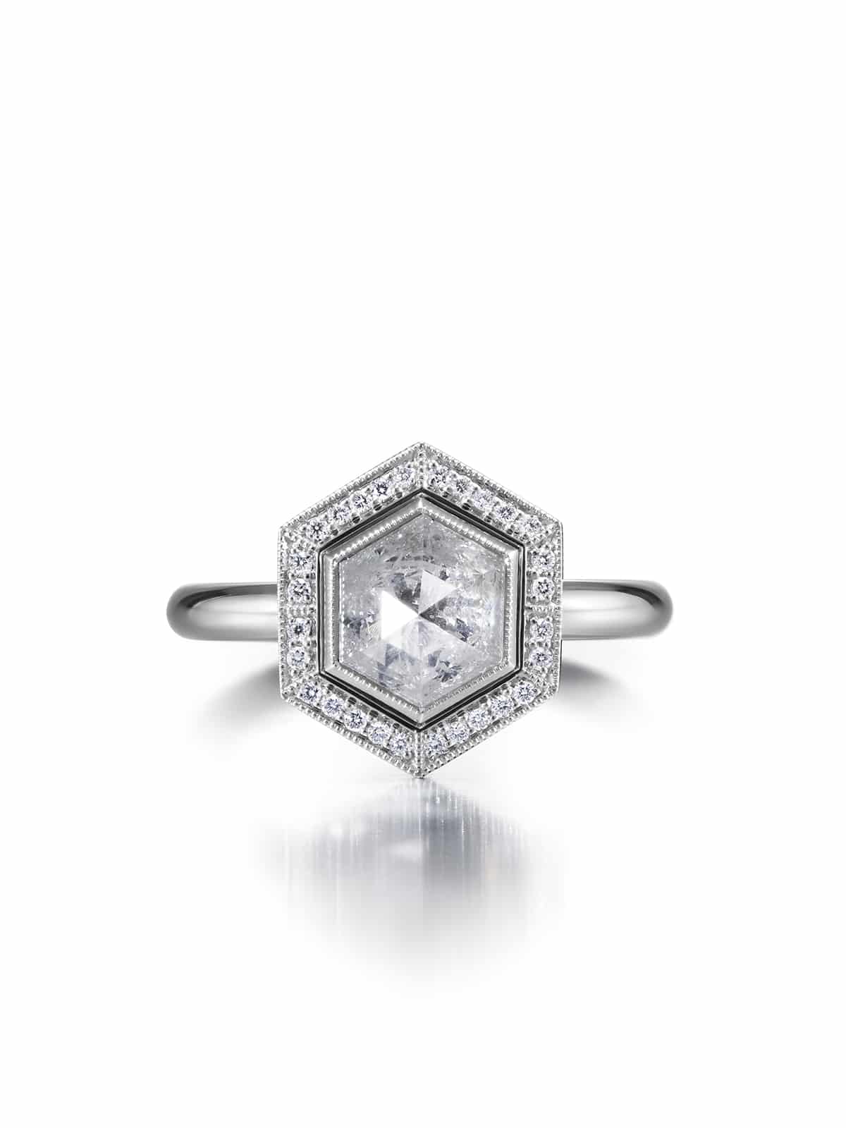 Ice Queen halo ring in platinum. Featuring a hexagon cut icy diamond surrounded by white diamonds in millgrain set.