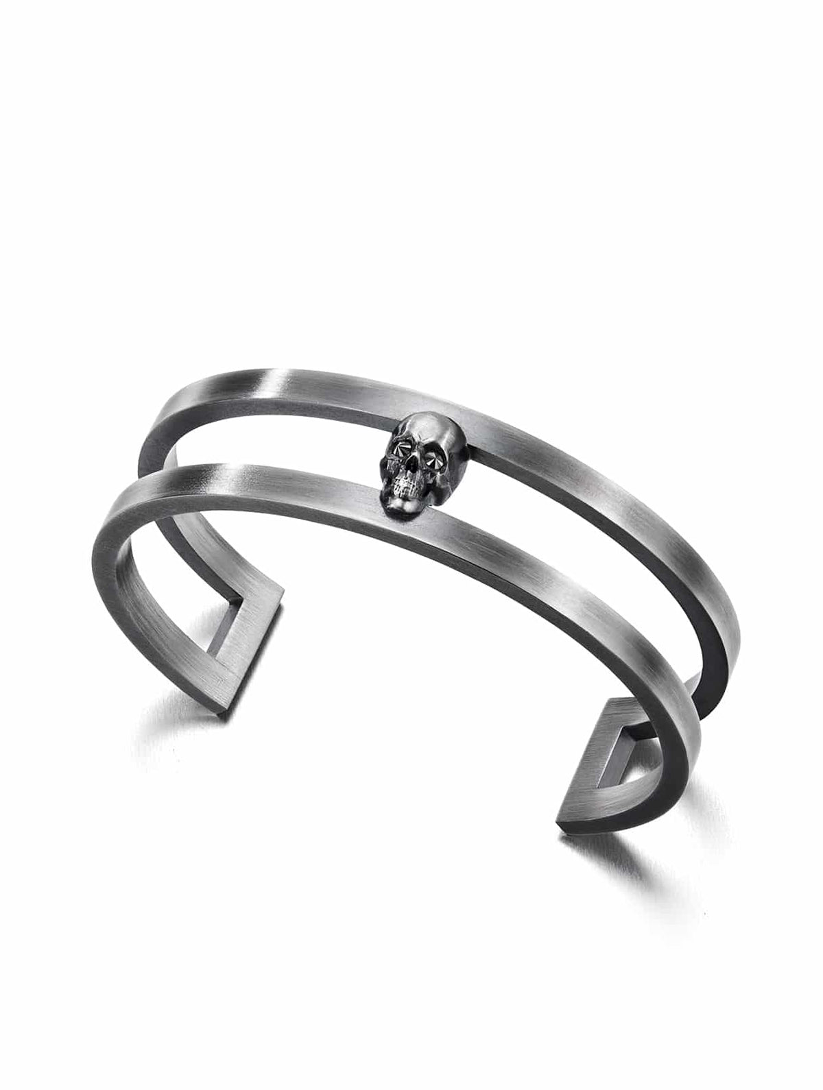 A silver cuff bracelet featuring a dark skull design with black diamonds set in the eye sockets.