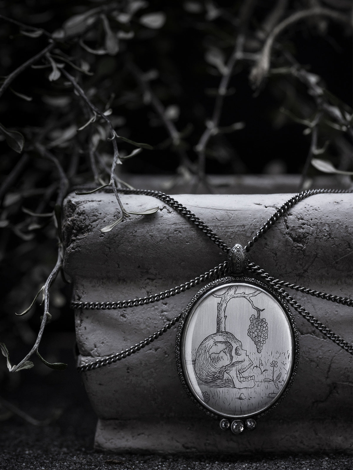 Post Festum – Hugo Simberg etching of skull with grapevine, artwork encased in the Post Festum Diamond Edition necklace by Heidi Vornan